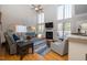 Bright living room with a fireplace, large windows, and a vaulted ceiling at 30155 Pharr, Chapel Hill, NC 27517