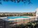 Large community pool is surrounded by mature trees and an iron safety fence at 3021 Polanski Dr, Wake Forest, NC 27587