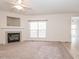 Comfortable living room features a cozy fireplace and a large window, perfect for relaxation and gatherings at 3021 Polanski Dr, Wake Forest, NC 27587