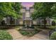 Beautiful brick building exterior featuring a lovely water fountain, trees and well-maintained landscaping at 3131 Hemlock Forest Cir # 304, Raleigh, NC 27612