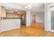 Open-concept living area blending kitchen and living space with hardwood floors and natural light at 3131 Hemlock Forest Cir # 304, Raleigh, NC 27612