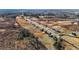 An aerial panorama captures a community with similar homes interspersed between natural landscape and a winding road at 3615 Nc-62, Burlington, NC 27217