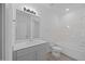Modern bathroom with a gray vanity, large mirror, and a tub/shower combo with white tiling at 3615 Nc-62, Burlington, NC 27217