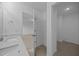 Elegant bathroom with a sink, mirror, and doorway to a separate room with shelving at 3615 Nc-62, Burlington, NC 27217