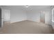 Cozy bedroom featuring neutral carpet, white walls, and doorways to other rooms at 3615 Nc-62, Burlington, NC 27217