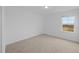 A bright bedroom features a large window for natural light and neutral carpeting at 3615 Nc-62, Burlington, NC 27217