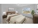 Serene bedroom with a plush bed, neutral tones, and a large window offering a neighborhood view at 3615 Nc-62, Burlington, NC 27217