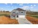 New two-story home boasts a modern design, attached garage, and a neatly paved driveway at 3615 Nc-62, Burlington, NC 27217
