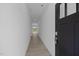 Long hallway with modern gray vinyl flooring and neutral walls leading to an open living space at 3615 Nc-62, Burlington, NC 27217
