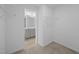 Bright walk-in closet with carpet flooring and wire shelving connected to a bathroom with a double sink vanity at 3615 Nc-62, Burlington, NC 27217