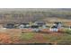 Aerial view of homes with light siding, dark roofs, surrounded by fields and forest at 3649 Nc-62, Burlington, NC 27217