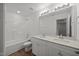 Bathroom with double sink vanity, quartz countertop, and bathtub with shower at 3649 Nc-62, Burlington, NC 27217