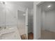 Bright bathroom features a double sink vanity with quartz counters and a linen closet at 3649 Nc-62, Burlington, NC 27217
