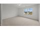 Bedroom with a large window allowing plenty of natural light and neutral carpeting at 3649 Nc-62, Burlington, NC 27217