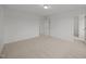 Bright, airy bedroom featuring neutral carpet, a ceiling light, and two open doorways at 3649 Nc-62, Burlington, NC 27217