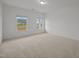 Bright bedroom with neutral carpet and two windows offering plenty of natural light at 3649 Nc-62, Burlington, NC 27217