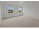 Bedroom featuring neutral carpeting and two windows with exterior views at 3649 Nc-62, Burlington, NC 27217