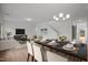 Bright dining and living area with hardwood floors, chandelier, and open floor plan at 3649 Nc-62, Burlington, NC 27217
