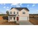 Charming two-story home featuring a classic design and a well-manicured front yard at 3649 Nc-62, Burlington, NC 27217