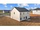 Two-story home featuring light siding, dark roof, patio, and an unfinished yard at 3649 Nc-62, Burlington, NC 27217