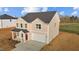 Beautiful two-story home with attached garage and inviting entrance, set in a serene landscape at 3649 Nc-62, Burlington, NC 27217
