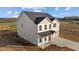 Rear exterior of a charming two-story home surrounded by lush greenery and natural light at 3649 Nc-62, Burlington, NC 27217
