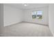 A spacious bedroom with large window provides ample natural light and a view of the surrounding neighborhood at 3655 Nc-62, Burlington, NC 27217