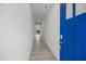 Bright entryway featuring wood-look flooring, white walls, and a blue front door at 3655 Nc-62, Burlington, NC 27217