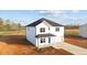Charming two-story white home featuring a covered porch and an attached garage at 3655 Nc-62, Burlington, NC 27217