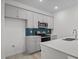 Modern kitchen with gray cabinets, stainless appliances, and a beautiful blue backsplash at 3655 Nc-62, Burlington, NC 27217