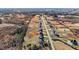 Overhead shot capturing the layout of a residential area with an array of houses alongside roads and natural terrain at 3689 Nc 62, Burlington, NC 27217