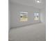 Bright bedroom with carpet, and two windows overlooking the outdoors at 3689 Nc 62, Burlington, NC 27217
