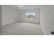 Bright bedroom featuring a large window offering an inviting space filled with natural light at 3689 Nc 62, Burlington, NC 27217