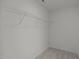 Walk in closet has a single wire rack for hanging items above the floor at 3689 Nc 62, Burlington, NC 27217