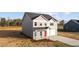 Charming two-story home features a gray exterior, red front door, and attached two-car garage at 3689 Nc 62, Burlington, NC 27217