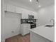 Modern kitchen with stainless steel appliances, white cabinets, and a stylish backsplash at 3689 Nc 62, Burlington, NC 27217