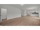 Open-concept living area with wood-look floors, stairs, and seamless flow to kitchen at 3689 Nc 62, Burlington, NC 27217