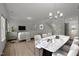 Open-concept living room and dining area featuring hardwood floors and modern decor at 3689 Nc 62, Burlington, NC 27217