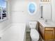 Bright bathroom featuring a bathtub, window, and modern sink and fixtures at 3810 Chehaw Dr, Raleigh, NC 27610