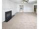 Spacious living room featuring a fireplace, carpet, and large window at 3810 Chehaw Dr, Raleigh, NC 27610