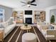 Cozy living room features a fireplace, ceiling fan, and built in bookshelves at 3810 Chehaw Dr, Raleigh, NC 27610