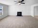 Bright living room features a fireplace, carpet, and large window at 3810 Chehaw Dr, Raleigh, NC 27610