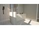 Bathroom featuring a sleek, modern design, tiled shower, and white cabinetry at 3813 Peaceful Creek Trl, Zebulon, NC 27597