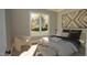 Cozy bedroom featuring a large window, chair, and stylish decor, perfect for relaxation at 3813 Peaceful Creek Trl, Zebulon, NC 27597