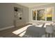 Serene bedroom featuring a large window, dresser, and hardwood floors, filled with natural light at 3813 Peaceful Creek Trl, Zebulon, NC 27597