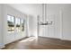 Bright dining room with hardwood floors and a modern chandelier at 3813 Peaceful Creek Trl, Zebulon, NC 27597