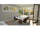 Elegant dining area with natural light, stylish furnishings, and easy access to the outdoor patio at 3813 Peaceful Creek Trl, Zebulon, NC 27597