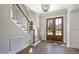 Elegant entryway with hardwood floors, double doors, and a modern staircase at 3813 Peaceful Creek Trl, Zebulon, NC 27597