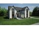Beautiful two-story home with brick and gray siding, large windows, professional landscaping, and a well-manicured lawn at 3813 Peaceful Creek Trl, Zebulon, NC 27597
