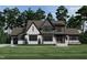 Two-story house with gray and white brick exterior, and a gabled roof at 3813 Peaceful Creek Trl, Zebulon, NC 27597
